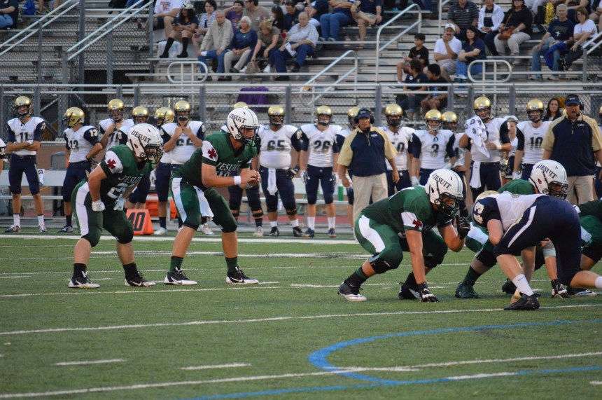 Zach Zubia '15 and Dwyer Bucey '15 prepare for the snap against the Rangers' defensive line. Photo : MAGIS